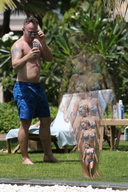 bikini collage blonde barefoot cleavage shrinking navel shrunken_woman grass standing sunny braid cellphone swim_trunks