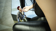 breasts gentle mini_giantess sitting looking_up touching digital_render fater leather_clothing chainlink_fence