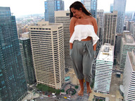 giantess collage city long_hair barefoot brunette unknown_artist grin looking_down outdoors caitlyn_pasternak