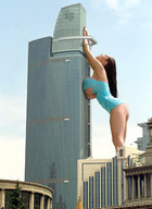 breasts giantess collage city long_hair butt huge_breasts brunette leaning_against_building stretching