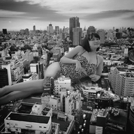 giantess collage city monochrome black_hair swimsuit buildings glasses smiling asian lying_down short_hair outdoors kyoujingirls