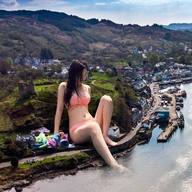 bikini giantess collage city long_hair clothed water buildings brunette sitting outdoors chainorchid