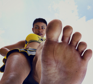 feet black_hair clothed toes barefoot soles low_angle cheerleader foot_crush looking_down dark_skin point_of_view looking_at_viewer raised_foot hands_on_hips imminent_crush digital_render flagg3d