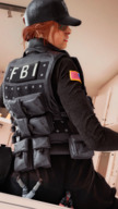 armor clothed glasses butt_crush military red_hair sitting shrunken_woman dark_skin indoors hat braid under_butt struggling face_paint digital_render rainbow_six_siege bantoras ash_(rainbow_six) frost_(rainbow_six) caveira