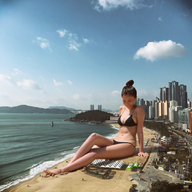 bikini breasts giantess collage city mega black_hair long_hair clothed beach water ocean sitting outdoors hair_bun kyoujingirls