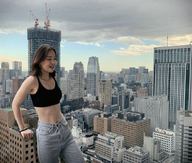 breasts giantess collage city mega long_hair buildings jeans brunette smiling asian leaning_against_building outdoors top bare_midriff kyoujingirls