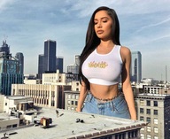 breasts giantess collage city mega black_hair long_hair clothed buildings shorts looking_down crop_top bare_midriff