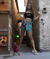 collage blonde long_hair clothed cleavage mini_giantess sandals shorts looking_down standing alley