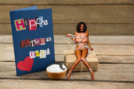 breasts nipples collage nude black_hair long_hair barefoot ribbon sitting shrunken_woman gift goingdown card