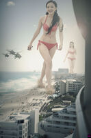 breasts giantess collage mega swimsuit destruction beach handheld barefoot rampage cleavage ocean helicopter brunette asian unknown_artist foot_crush giantesses palm_trees earrings hotel bare_midriff
