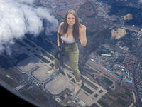 breasts collage city mega long_hair cleavage gun brunette unknown_artist airplane pants airport top combat_boots backpack cracked_ground plane_view foot_prints