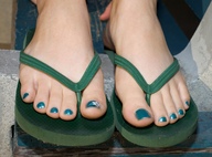 feet shrunken_men shrunken_man photograph flip_flops sandy point_of_view
