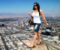 landscape city mega black_hair long_hair cleavage shoes walking sunglasses sky las_vegas