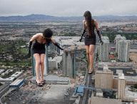 city black_hair long_hair destruction cleavage high_heels gloves legs short_skirt giantesses