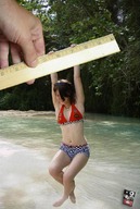 collage swimsuit barefoot brunette shrunken_woman dangle river ruler hanging_on giant_hand