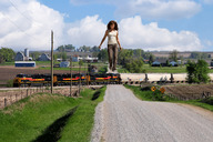 giantess collage black_hair clothed train wonderslug farm walking looking_down outdoors sunny trees freight_train countryside heat_haze olga_kurylenko