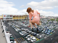 giantess collage handheld red_hair vehicles crouching pink_dress parking_lot black_boots karen_gillan bending_down kneeling_down behind_view