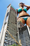 giantess collage city blonde large_breasts swimsuit low_angle navel sunglasses sky sunny cranes