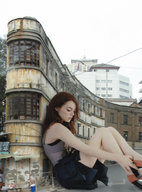 giantess collage skirt high_heels sitting legs leaning_against_building docop emma_stone