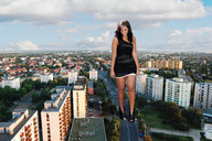 giantess collage city black_hair buildings smiling wonderslug legs looking_down streets vehicles dark_skin black_dress vehicle_crush black_ankle_boots